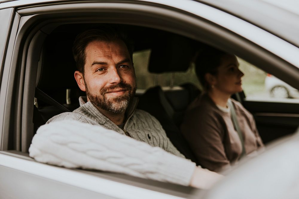 Smiling man sitting in car photo