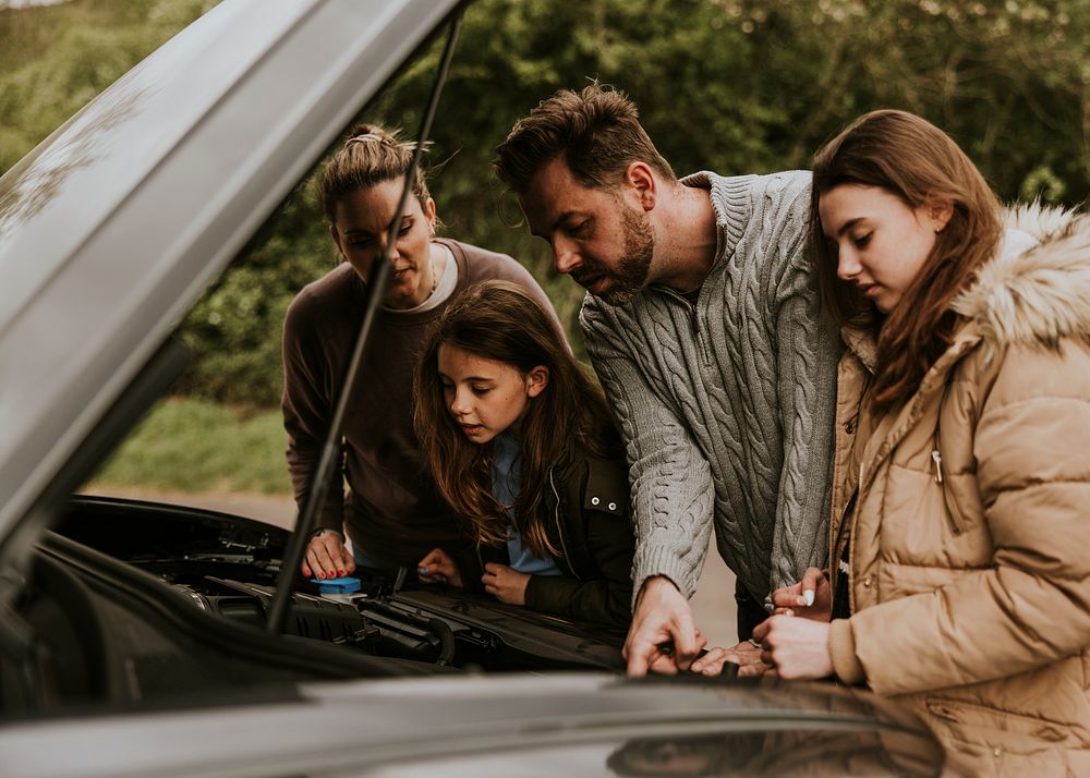 Family with broken car photo