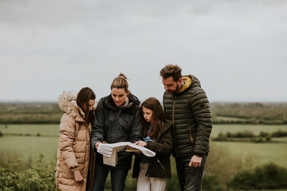 Traveling family looking at map photo