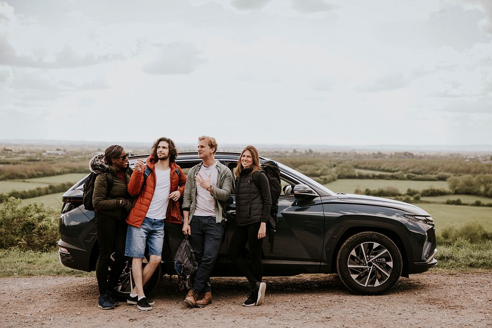 Friends enjoying road trip on hill photo