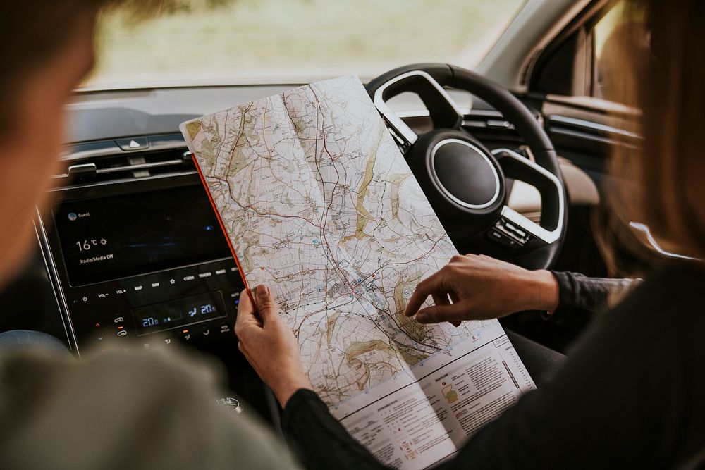 Driver looking at map in car photo