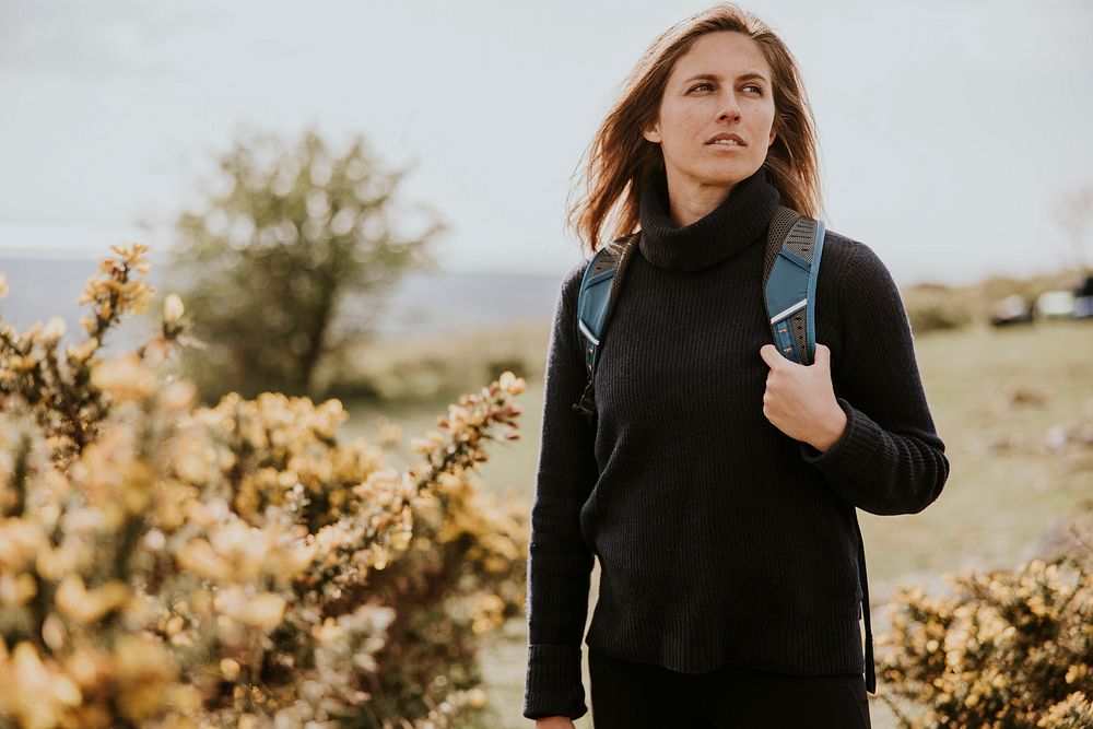 Woman hiking on hill, outdoor activity photo