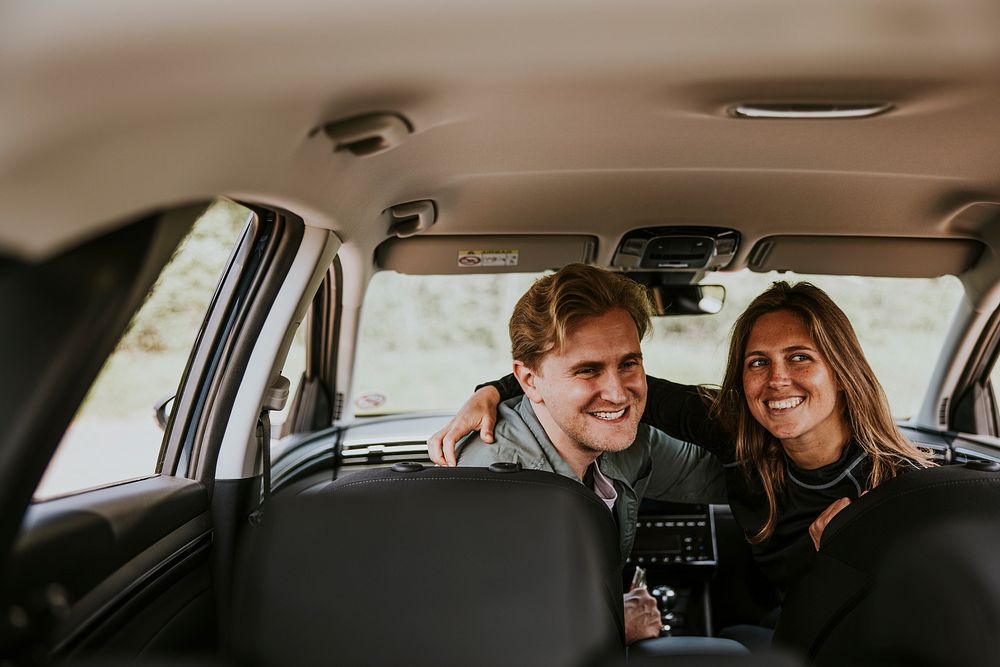 Happy couple taking photo in car photo