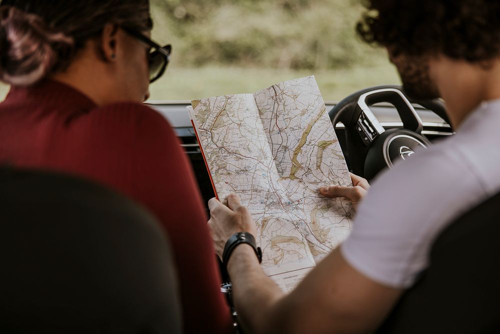 Couple looking at map in car photo
