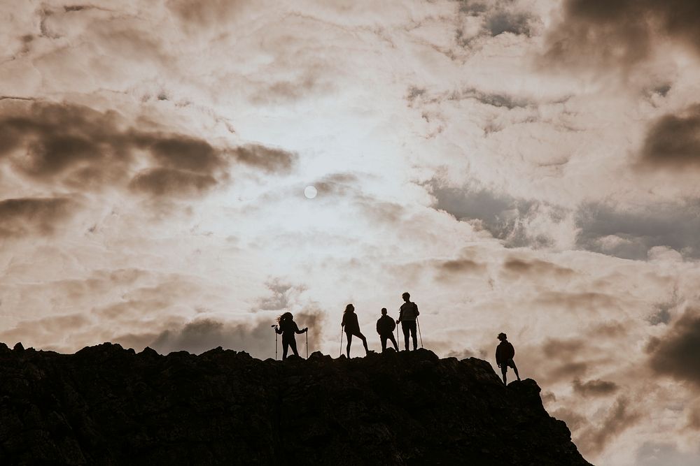 Silhouette of hikers walking on mountain