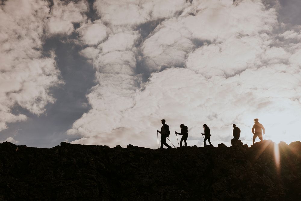 Silhouette of hikers walking on mountain
