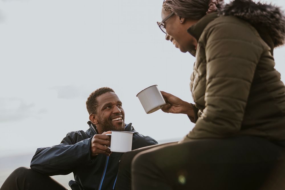 Camping couple having morning drinks