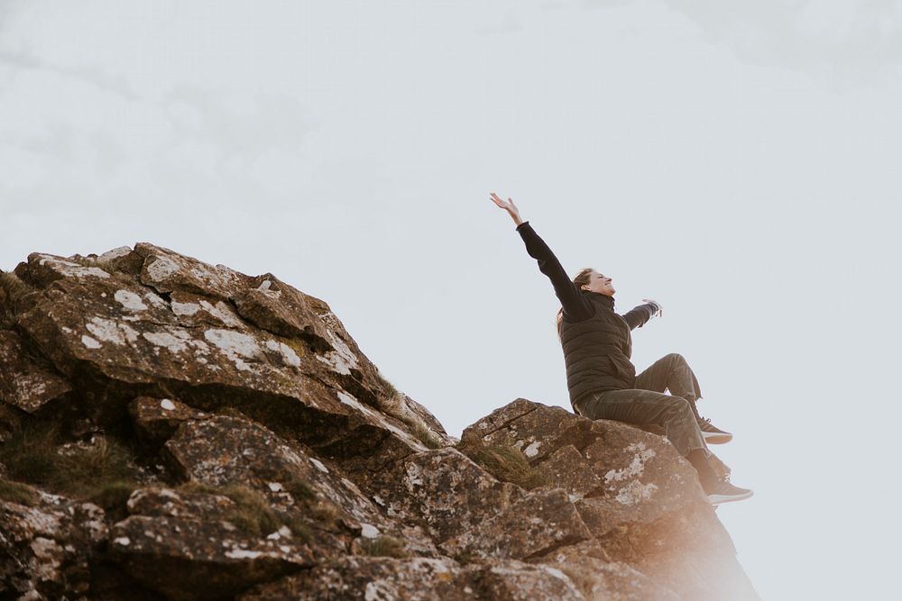 Woman sitting on the edge of a cliff photo