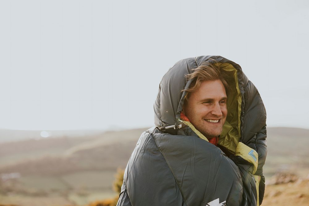 Smiling man in sleeping bag jacket, apparel photo