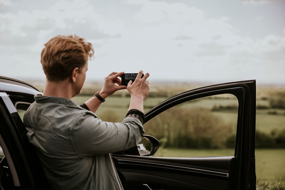 Man taking photo on road trip photo