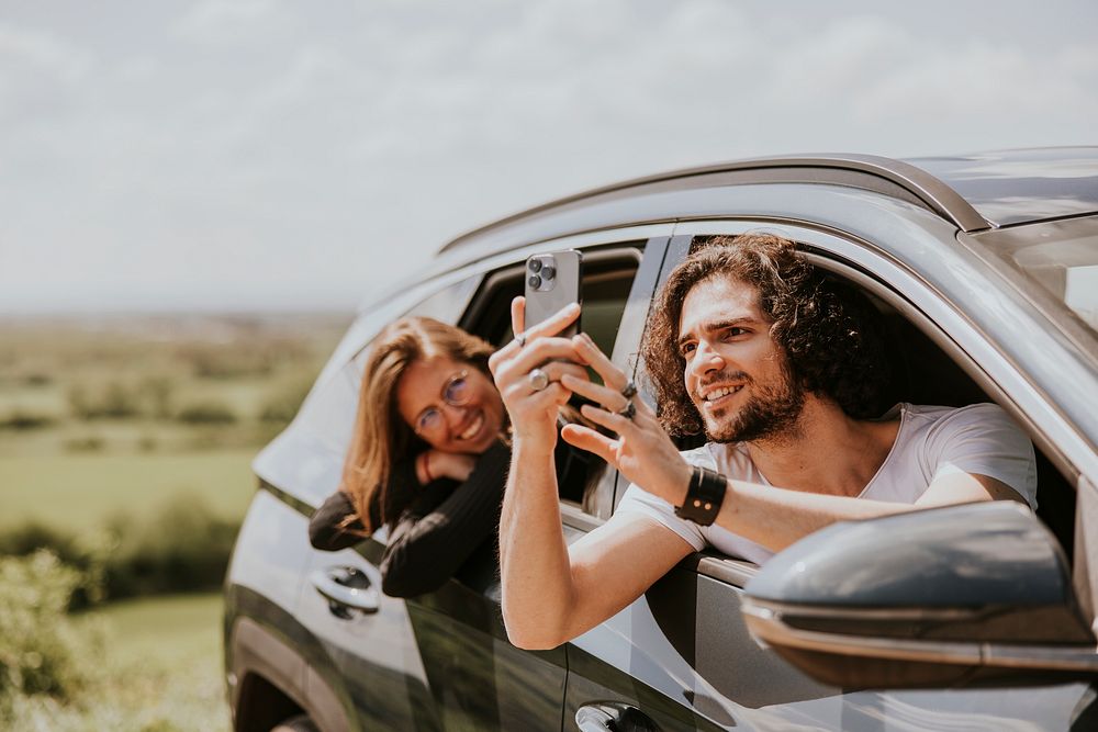 Man taking photo on road trip photo