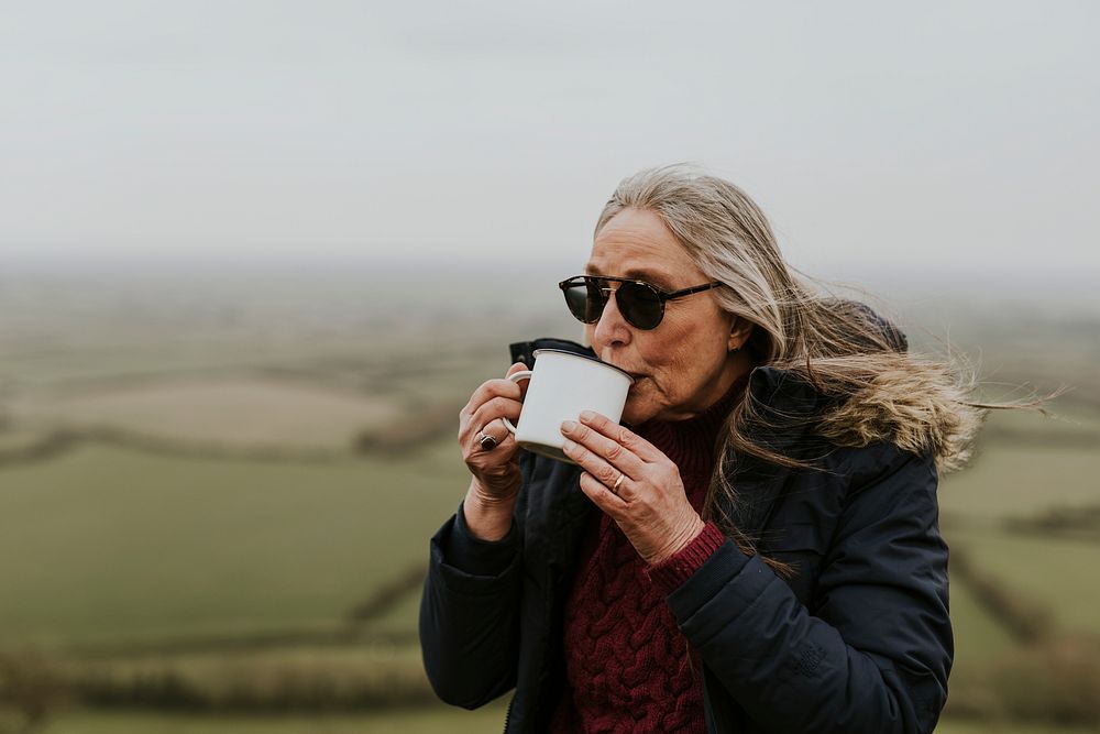 Senior camping woman drinking coffee