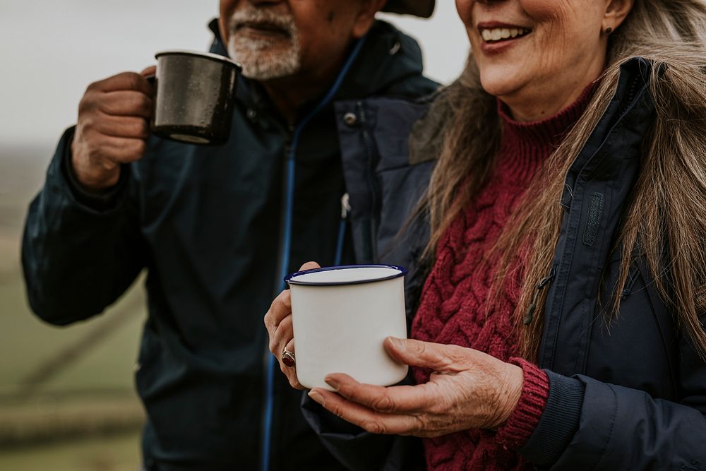 Senior camping couple drinking coffee