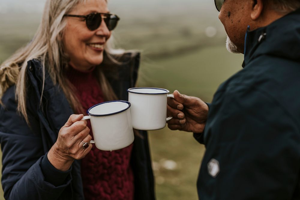 Senior camping couple drinking coffee