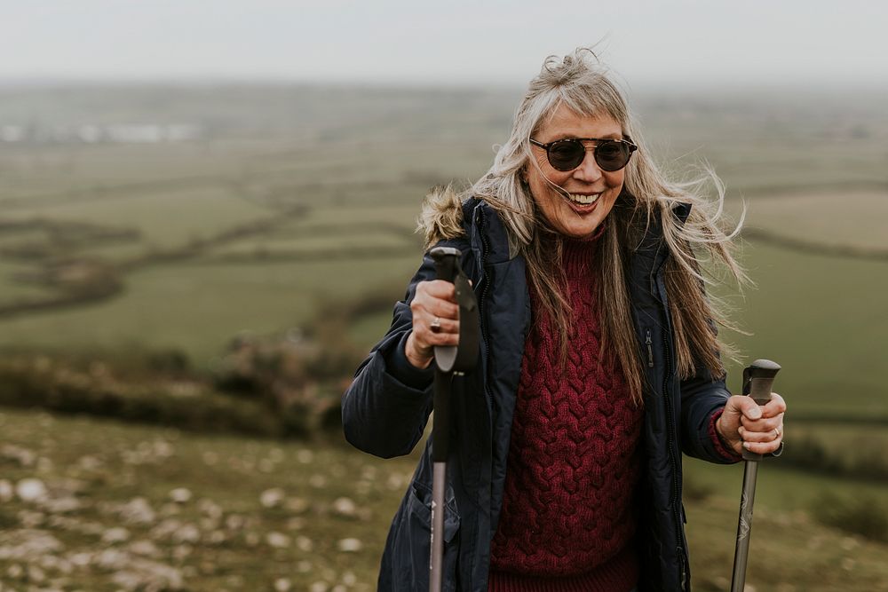 Senior woman hiking mountain, countryside, outdoor travel