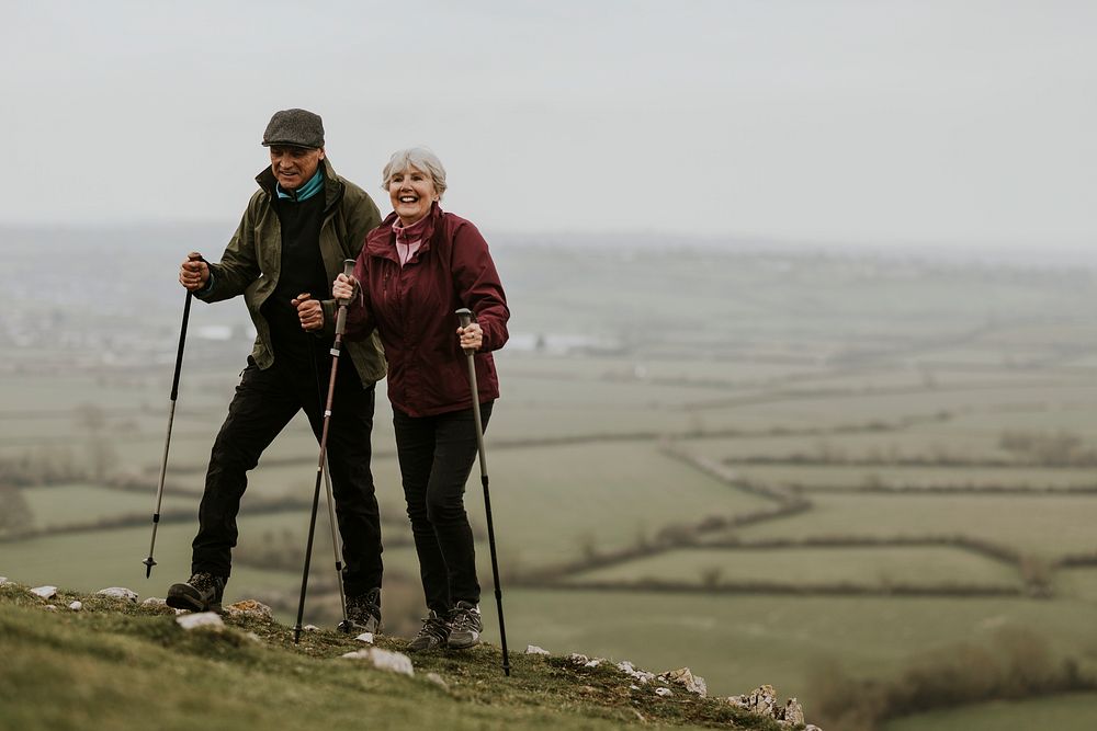 Senior couple hiking mountain, countryside, outdoor travel