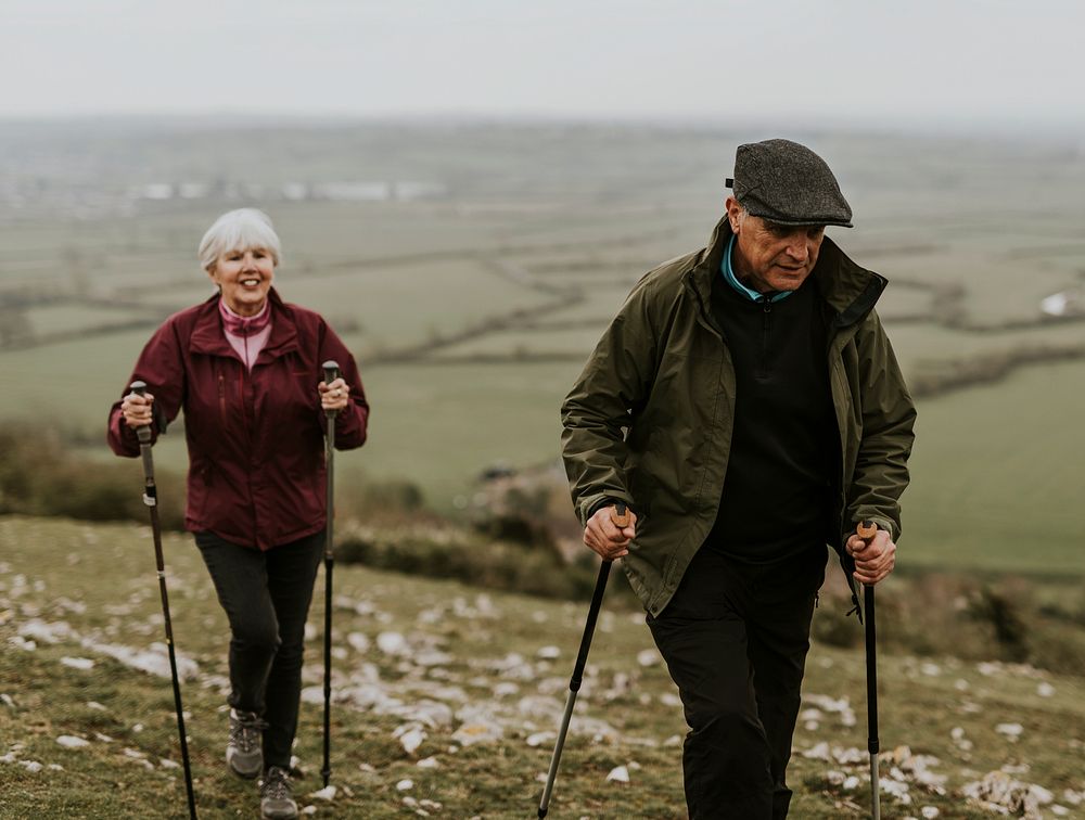 Senior couple hiking mountain, countryside, outdoor travel