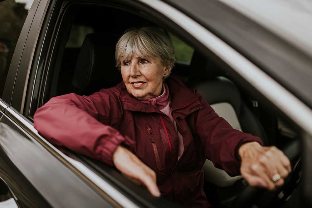 Senior woman driving car, travel photo