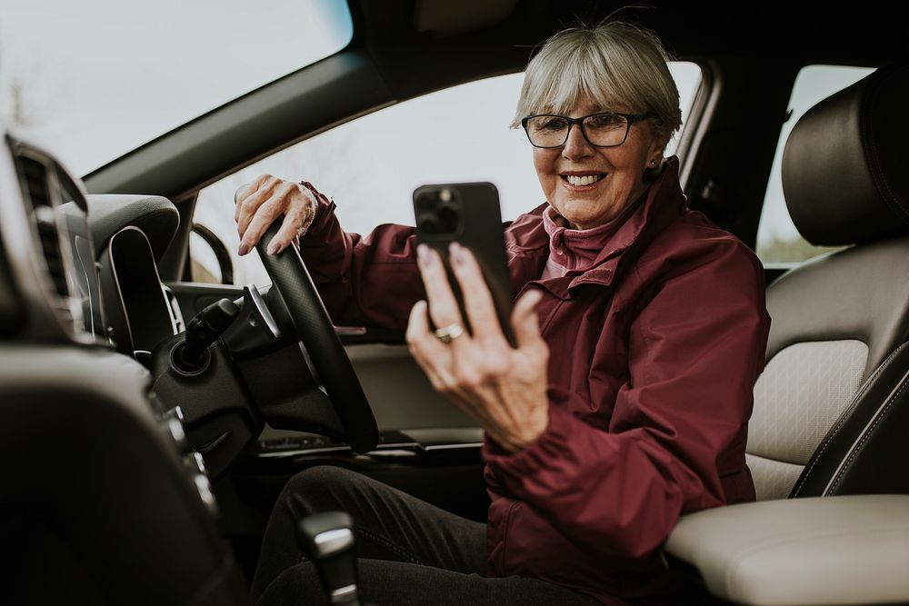 Driving senior woman video calling