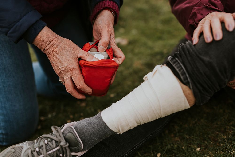 Woman wrapping elastic bandage, first aid