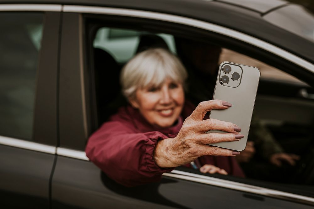 Senior woman video calling in her car