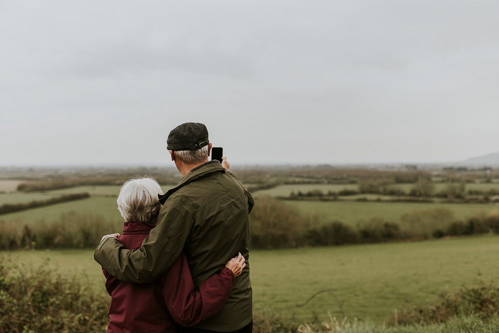 Senior couple hugging, outdoor travel photo