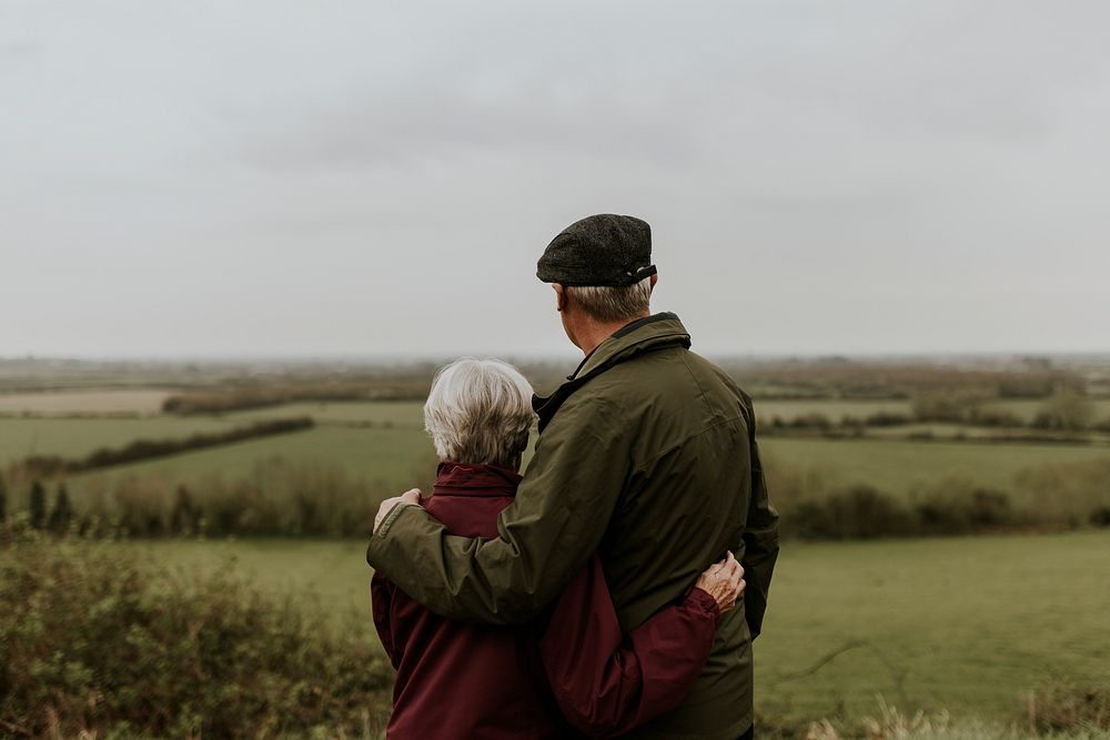 Senior couple hugging, outdoor travel photo