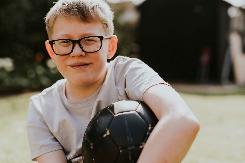 Cheerful boy holding a football