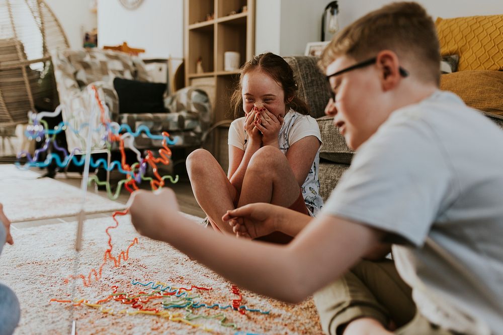 Happy siblings playing buzz wire game