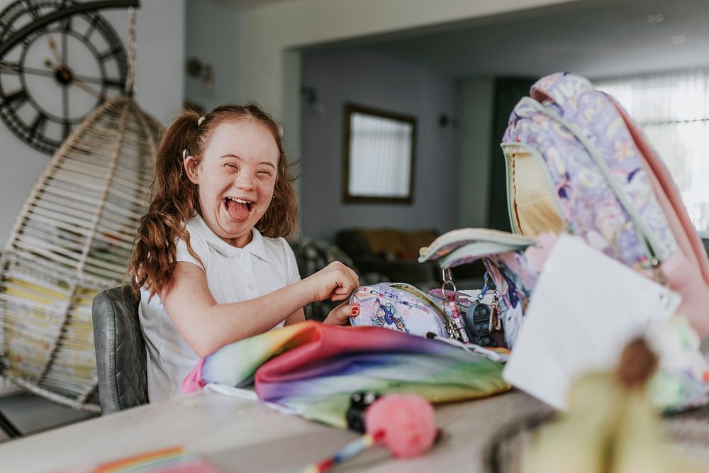 Happy girl with down syndrome ready for school