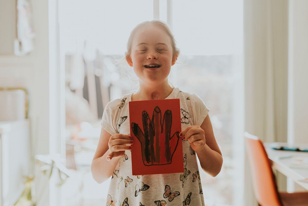 Girl with Down Syndrome showing drawing