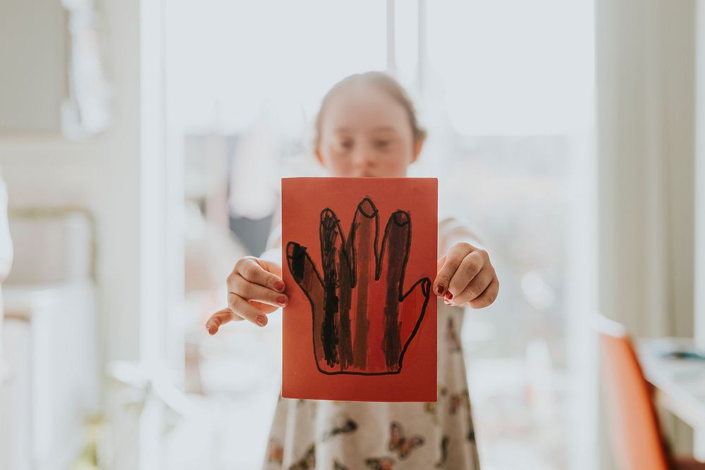 Girl with Down Syndrome showing drawing