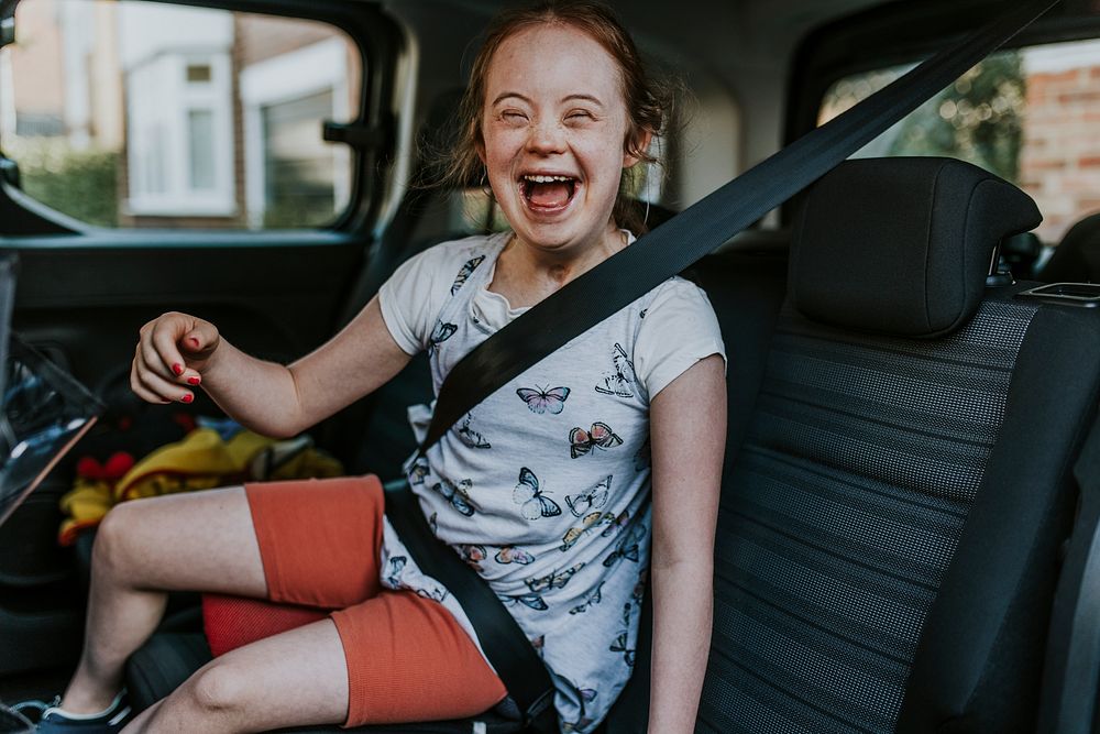 Down syndrome girl in car backseat