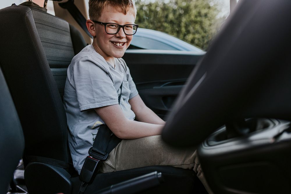 Boy sitting in car backseat