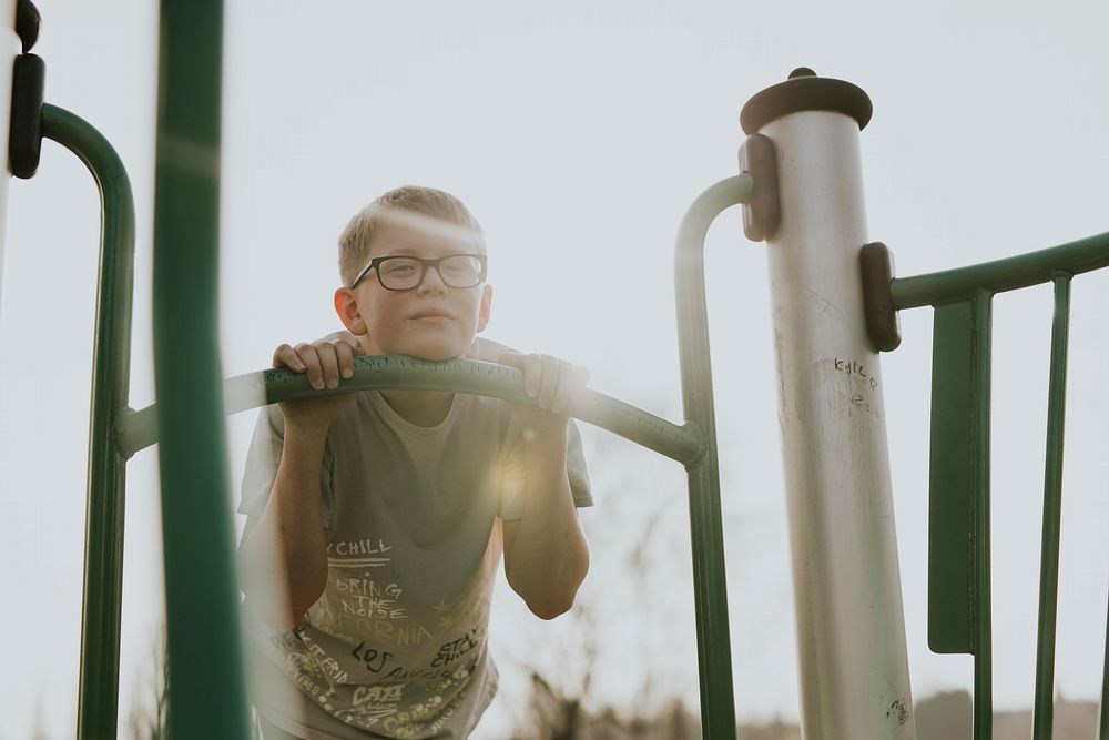 Happy boy having fun, playground photo