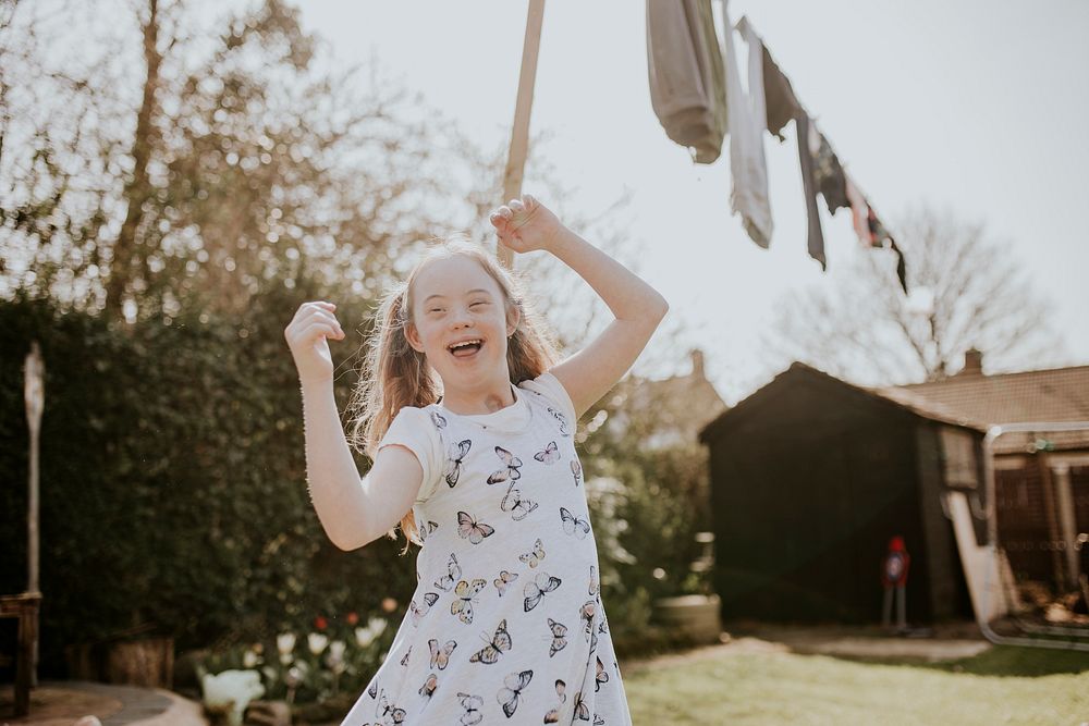 Happy girl with Down Syndrome, backyard photo