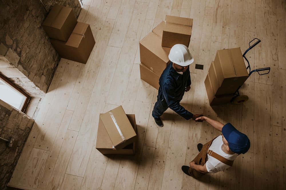 Removal service workers shaking hands