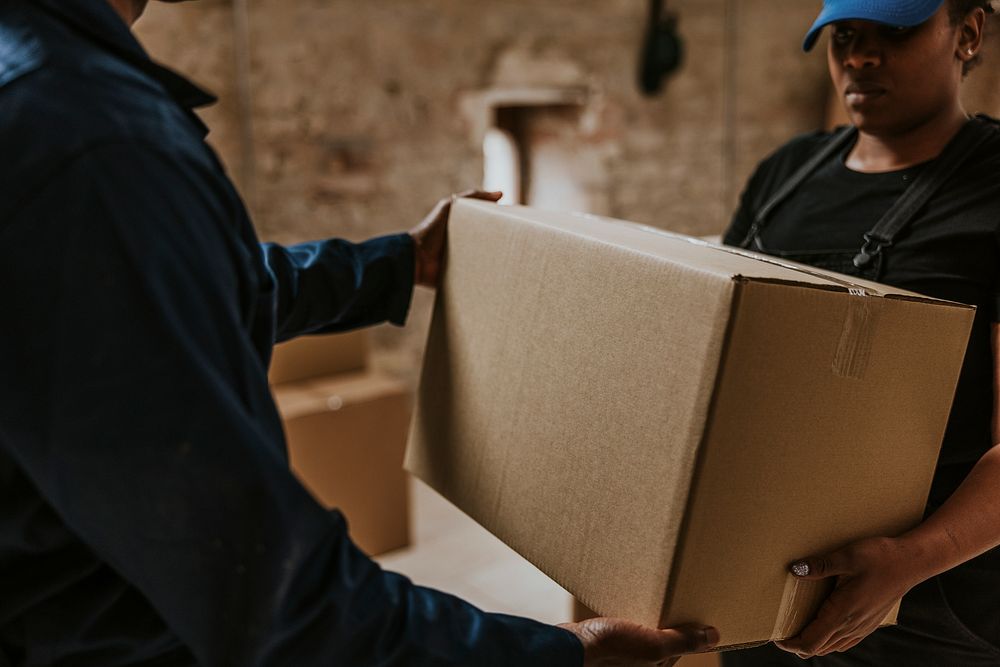 Delivery man handing box to customer