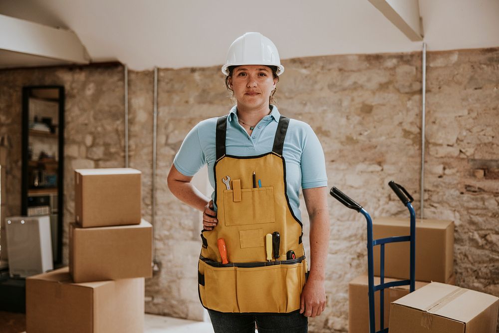 Construction worker wearing handyman apron with tools