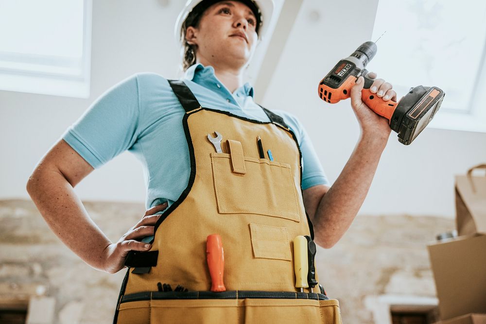 Construction worker wearing handyman apron with tools