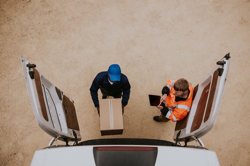 Removal service worker unloading box from the van