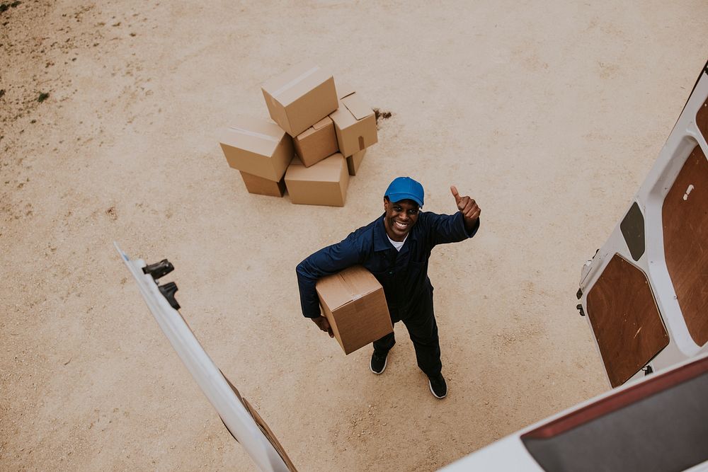 Removal service worker unloading box from the van