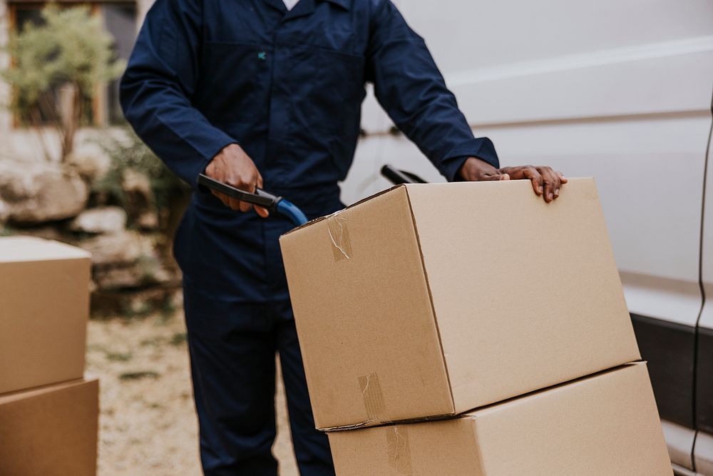 Worker unloading boxes, removal service job