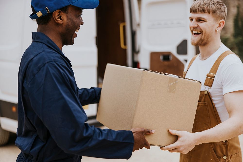 Delivery man handing box to customer