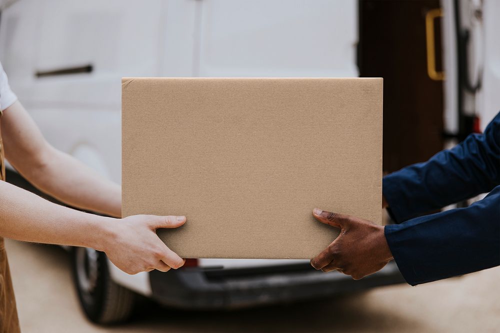Delivery man handling box customer Premium Photo rawpixel