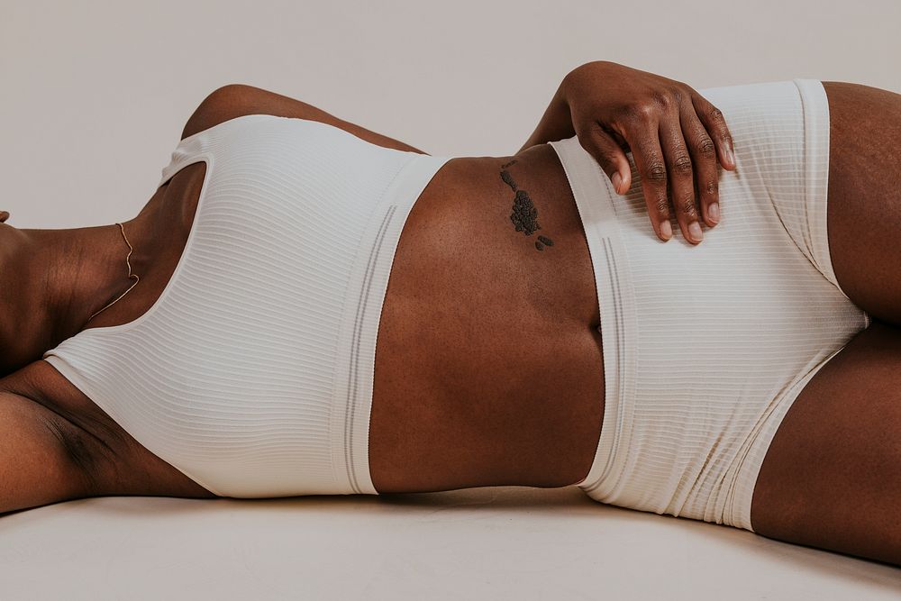 Closeup African woman body lying on floor photo