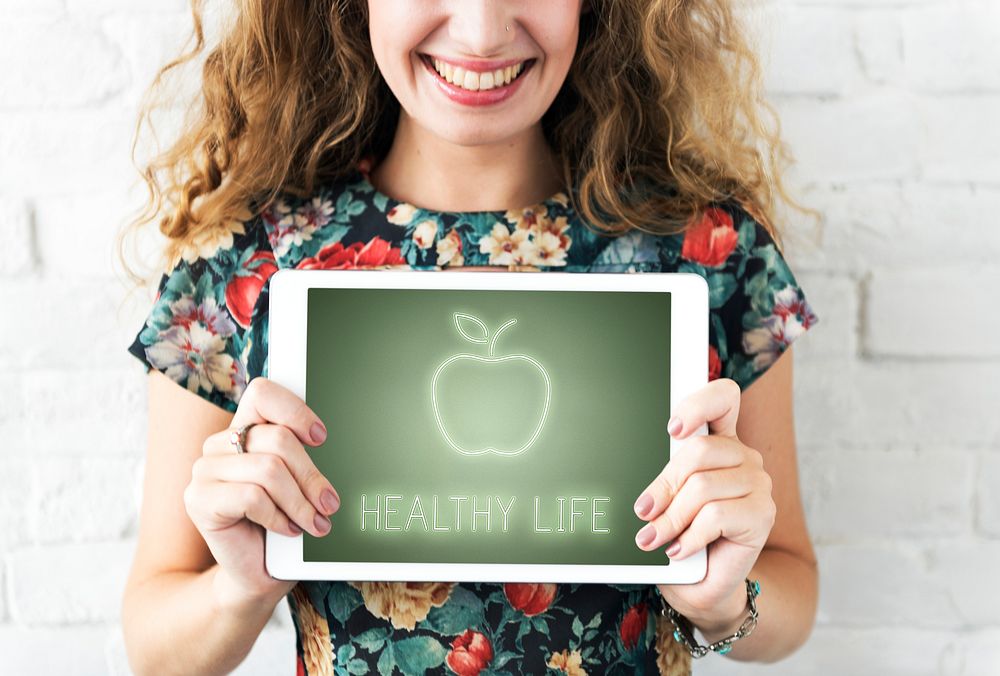 Smiling woman holding tablet.