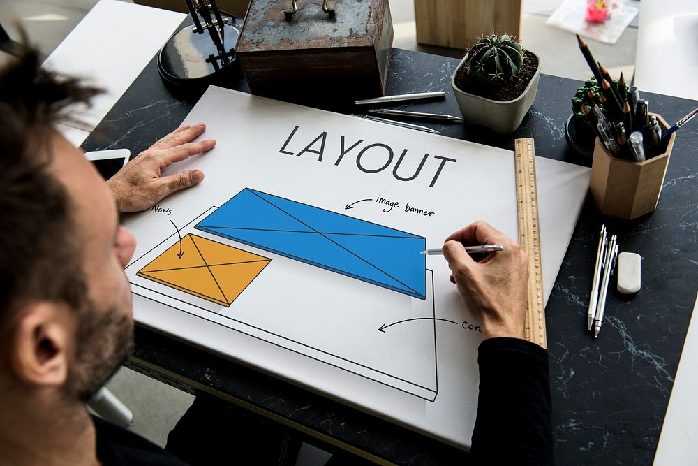 Man working on billboard network graphic overlay on table