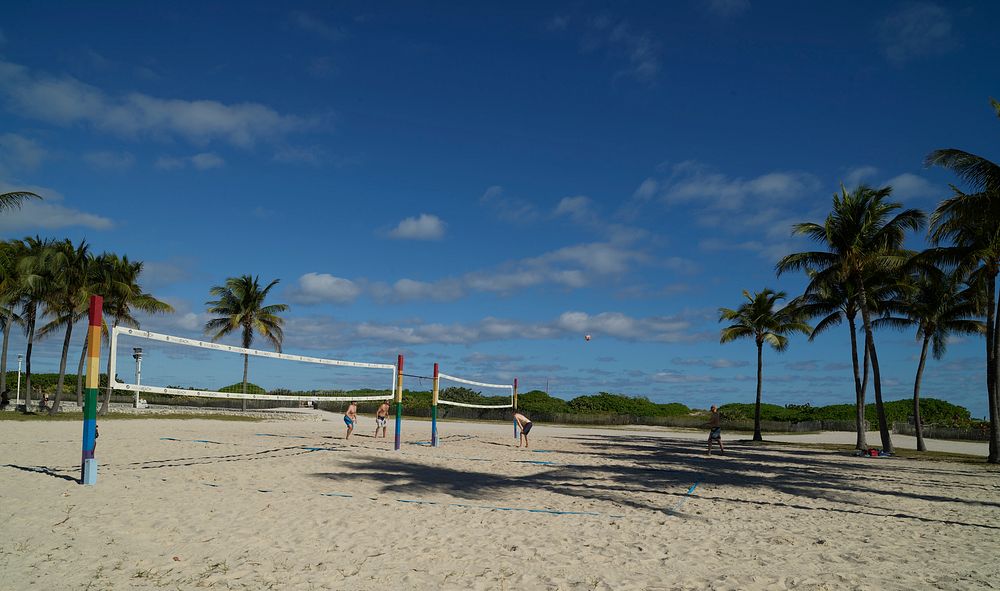                         Even though the two volleyball players to the left of the net have a manpower advantage, one of them…