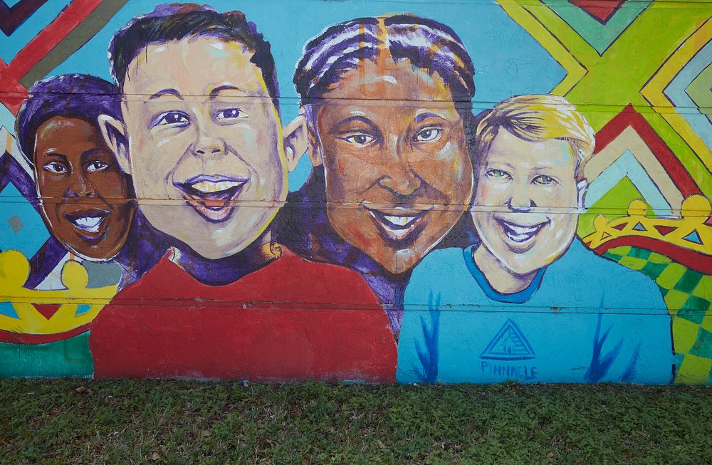                         Murals on a long wall next to the North District police station in the Liberty City neighborhood of…
